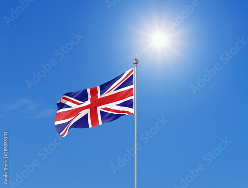 3D illustration. Colored waving flag of United Kingdom on sunny blue sky background.
