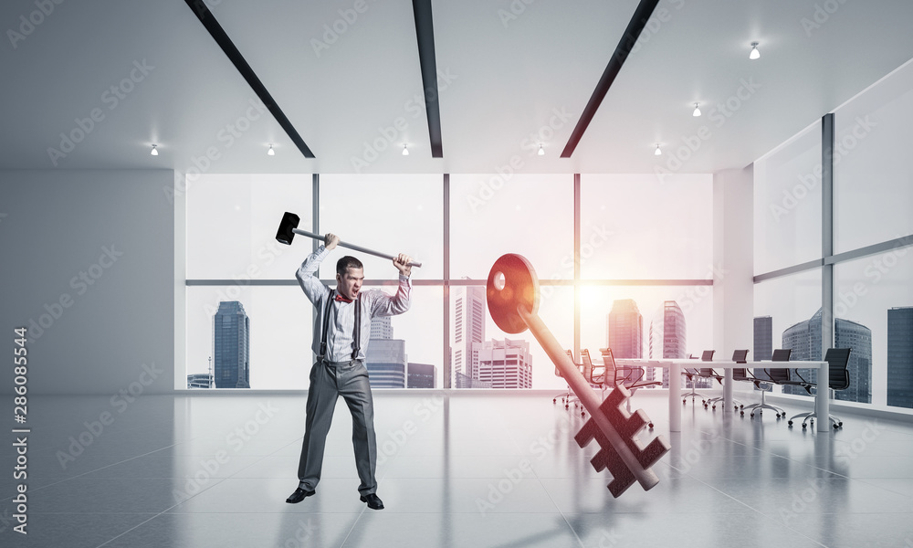 Breaking through access concept with man in crashing concrete key