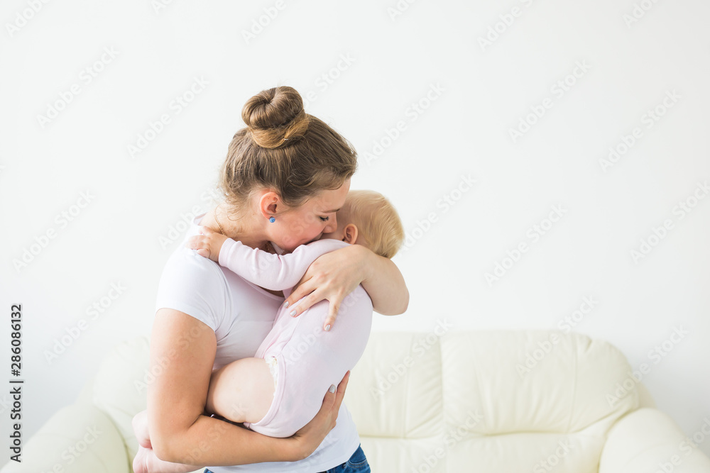 Mother hugs little baby. Happy woman with her daughter Mother hugs little baby. Happy woman with her daughter
