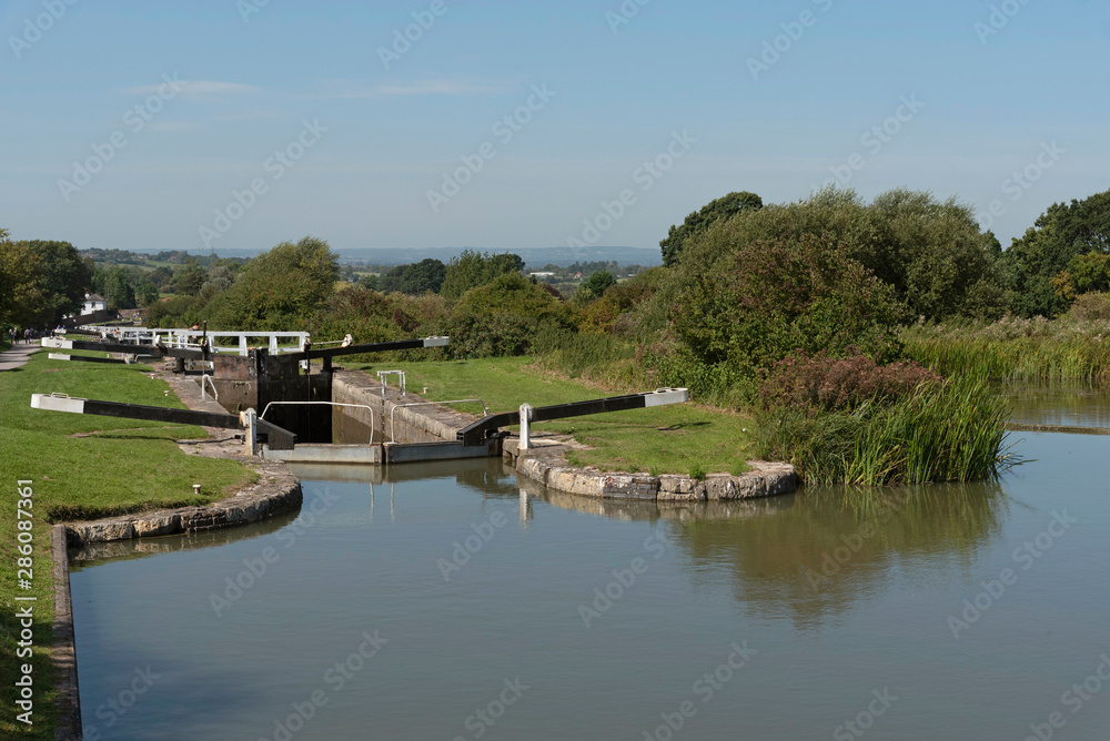 Obraz premium Devizes, Wiltshire, England, UK. August 2019. A lock on the Kennet and Avon Canal,