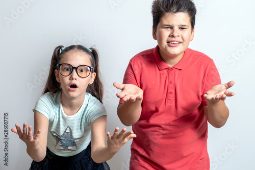 A little girl and a boy are surprised. Children don't understand what's going on.
