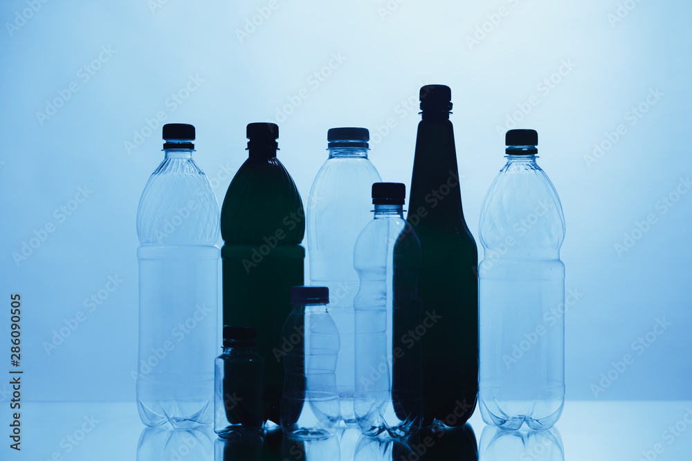 empty plastic bottle silhouettes on blue background empty plastic bottle silhouettes on blue background