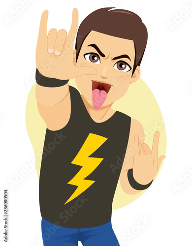 Young man rocking making horns hand gesture and showing tongue