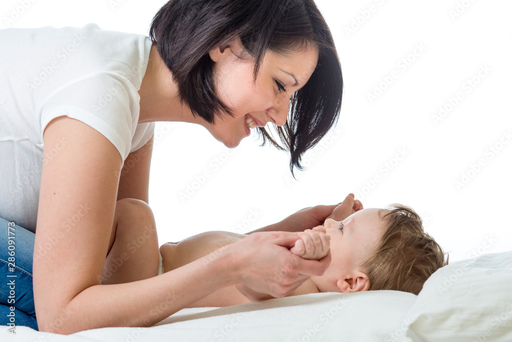 Loving mother playing with her baby isolated on white background Loving mother playing with her baby isolated on white background