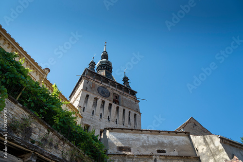 View of the clock tower of the medieval citadel of Shigisoara  in Transylvania  Romania .