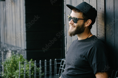 Stylish handsome man wearing sunglassesand smiling