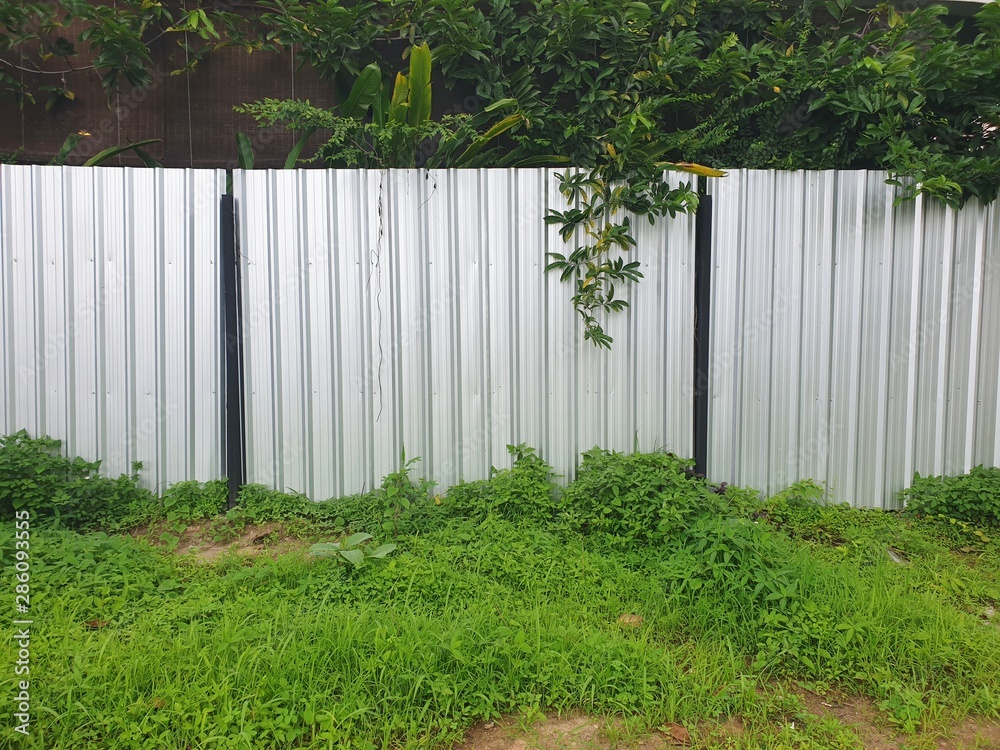 empty aluminum wall with green leave texture,Gray aluminum color. empty aluminum wall with green leave texture,Gray aluminum color.