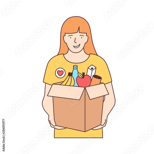 Smiling female volunteer carrying box with fruits and other products isolated on white background