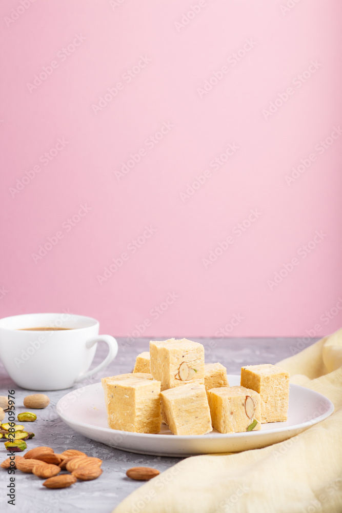 traditional indian candy soan papdi in white plate with almond and ...
