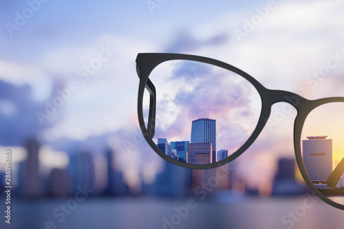 Modern bright city view through eyeglasses