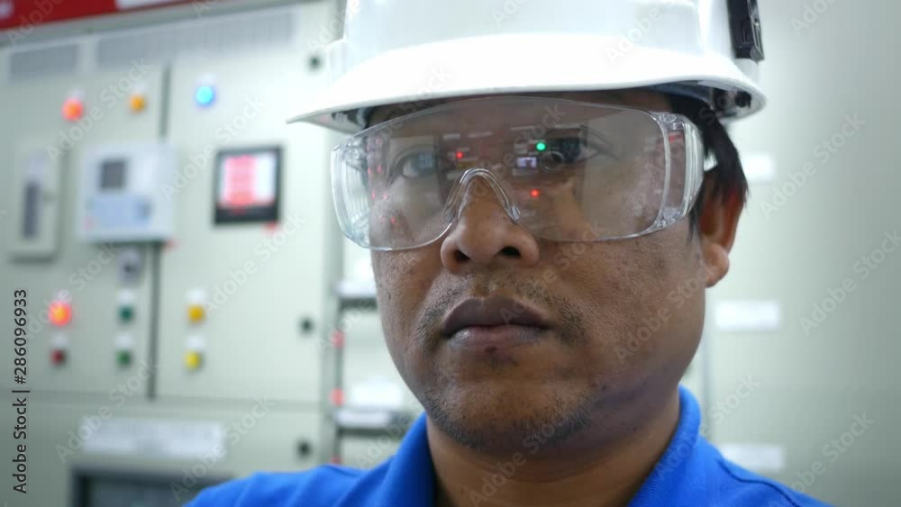 Engineer working in electricity substation building for check and monitor electrical control equipment , Industrial and technology concept Engineer working in electricity substation building for check and monitor electrical control equipment , Industrial and technology concept