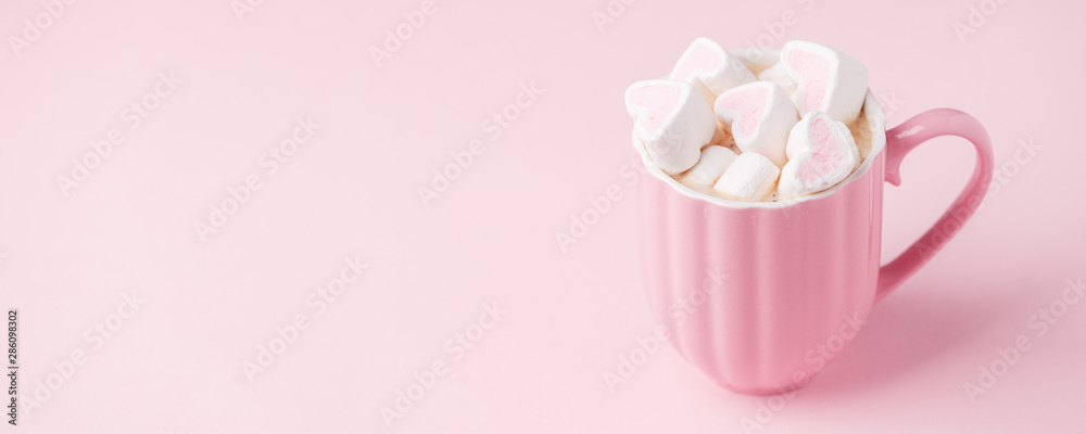 Pink light pastel background. Cup of dark coffee, hearts shaped marshmallow. Valentine's wedding day concept. Romantic girly femininy background Pink light pastel background. Cup of dark coffee, hearts shaped marshmallow. Valentine's wedding day concept. Romantic girly femininy background