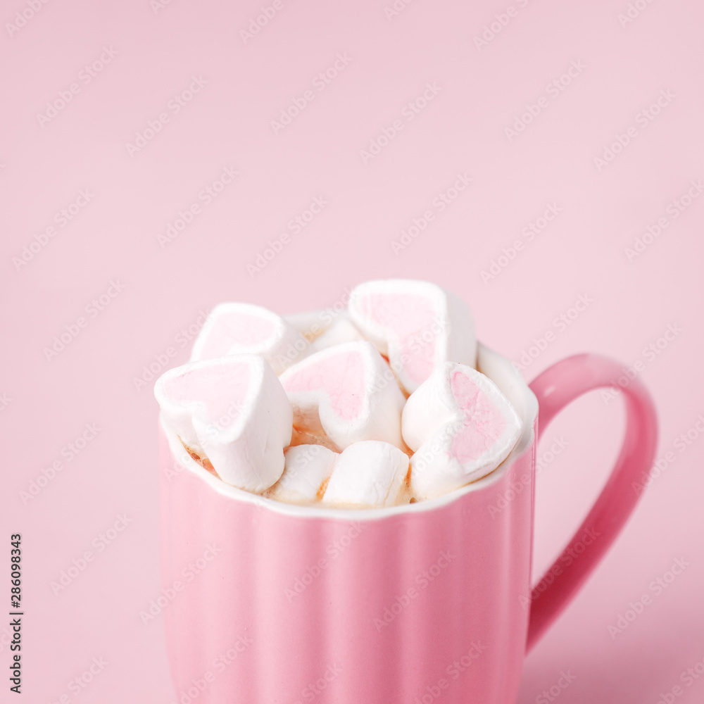 Pink light pastel background. Cup of dark coffee, hearts shaped marshmallow. Valentine's wedding day concept. Romantic girly femininy background Pink light pastel background. Cup of dark coffee, hearts shaped marshmallow. Valentine's wedding day concept. Romantic girly femininy background