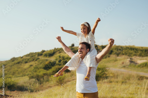 Father and daughter have fun in nature
