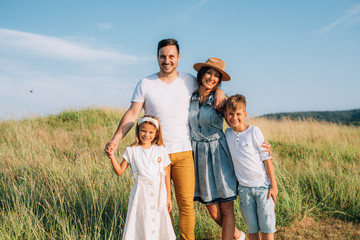 Happy family in nature. Happy family: mother, father, children son and daughter. life is made of little things.