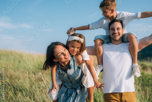 Happy family in nature. Happy family: mother, father, children son and daughter. life is made of little things.