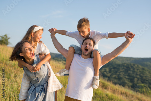 Happy family in nature. Happy family: mother, father, children son and daughter. life is made of little things.
