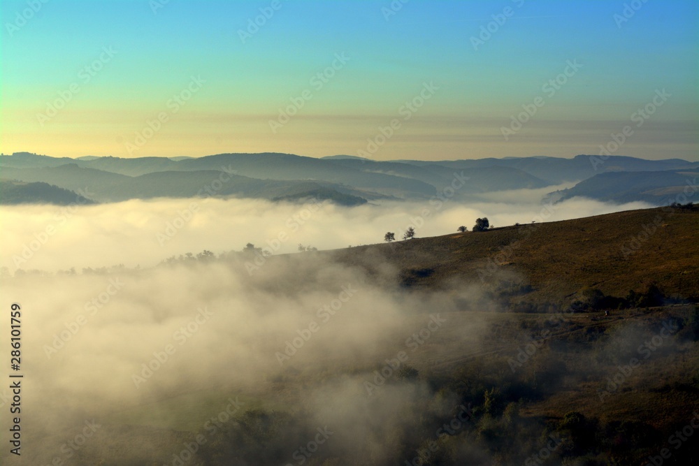 fog between hills in the morning