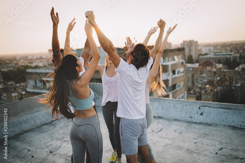 Fitness, sport, friendship and healthy lifestyle concept - group of happy sporty friends photo