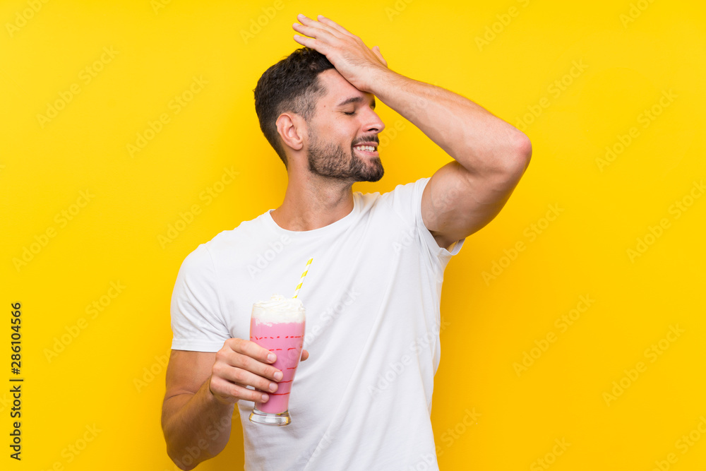 Young man with strawberry milkshake over isolated yellow background has realized something and intending the solution Young man with strawberry milkshake over isolated yellow background has realized something and intending the solution