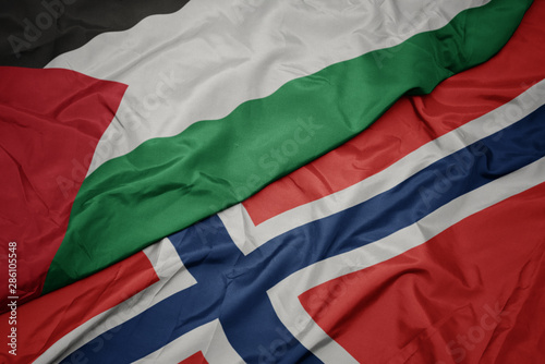 waving colorful flag of norway and national flag of palestine.