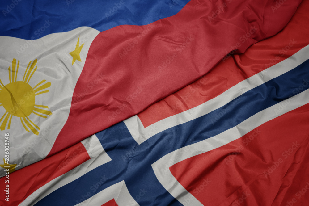 waving colorful flag of norway and national flag of philippines.