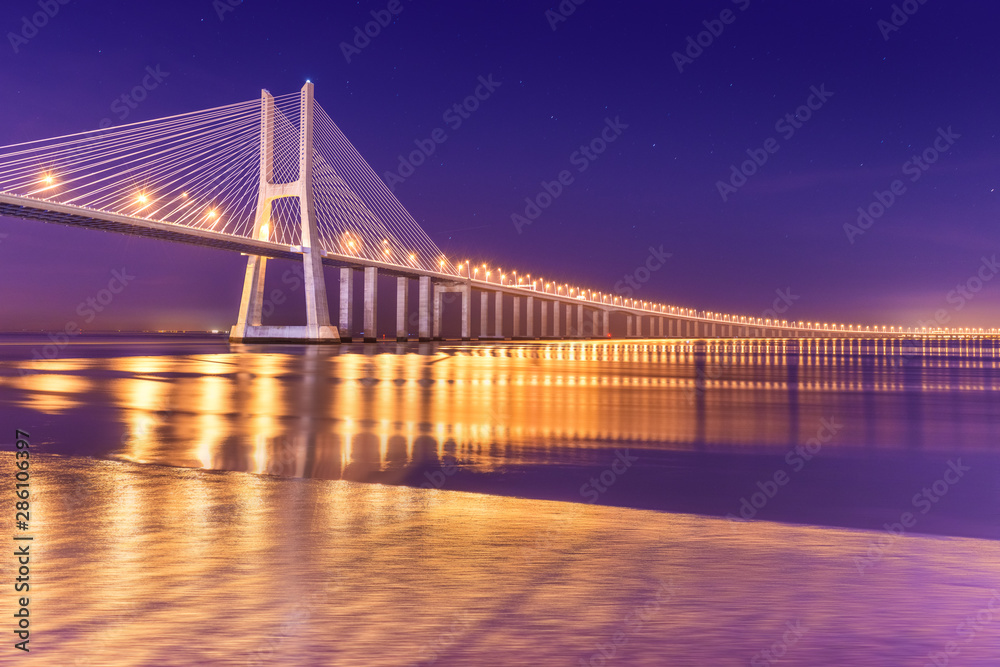 View of a modern cable-stayed bridge at night (Vasco da Gama Bridge), Lisbon, Portugal