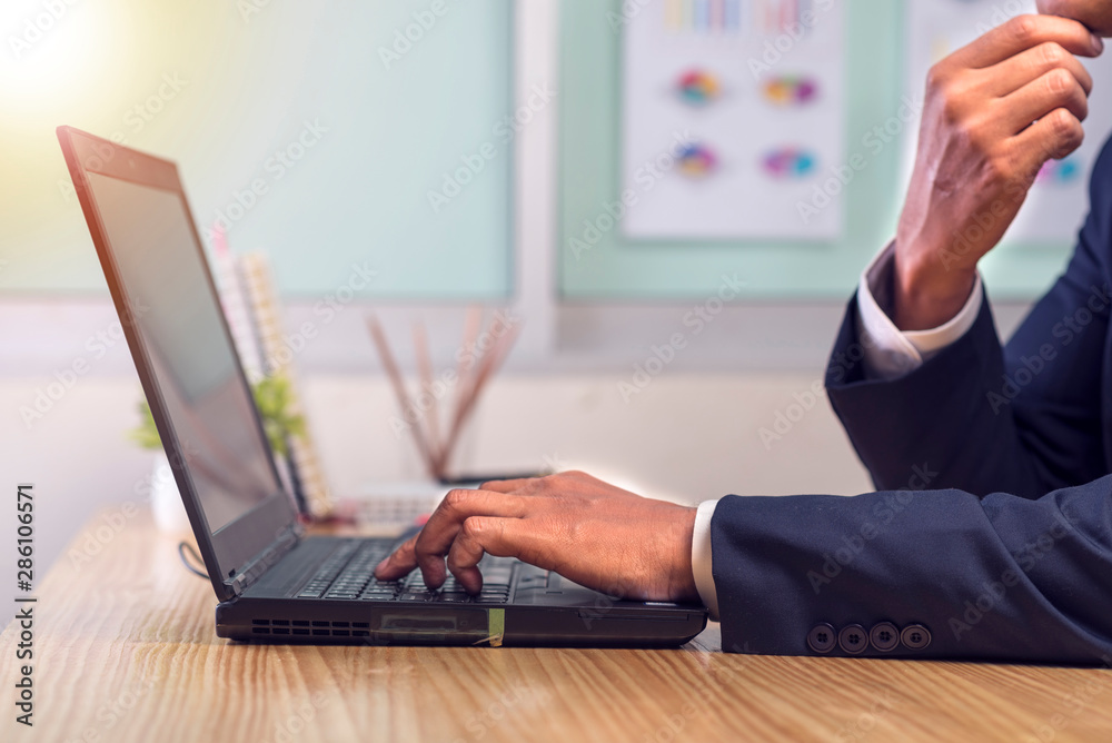 Asian businessman hands on the keyboard Working at home office with laptop,Data Processing business concept. Asian businessman hands on the keyboard Working at home office with laptop,Data Processing business concept.