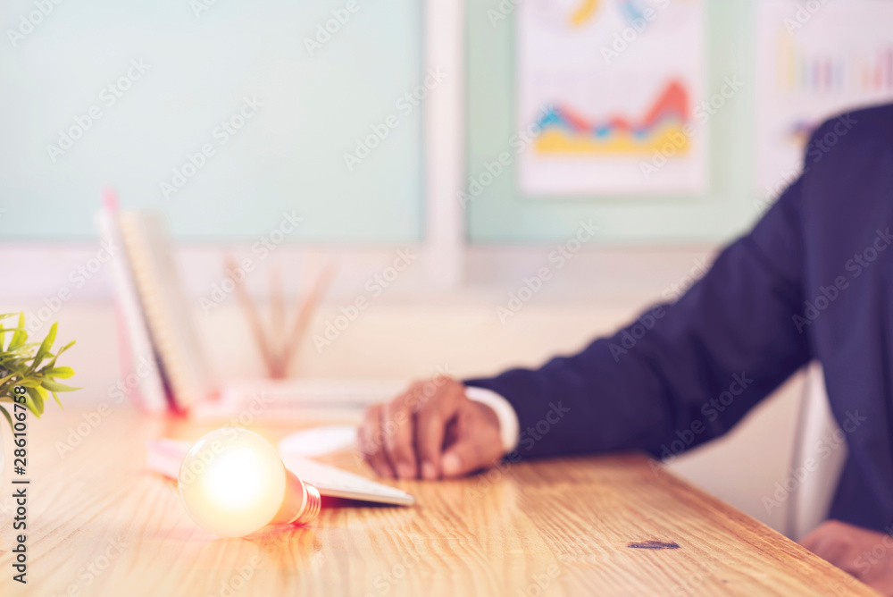 Light bulbs on wood table at home office desk background.,Concept idea and innovation. Light bulbs on wood table at home office desk background.,Concept idea and innovation.