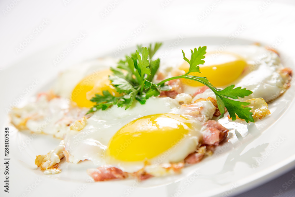 fried eggs and omelet with vegetables on a white background fried eggs and omelet with vegetables on a white background
