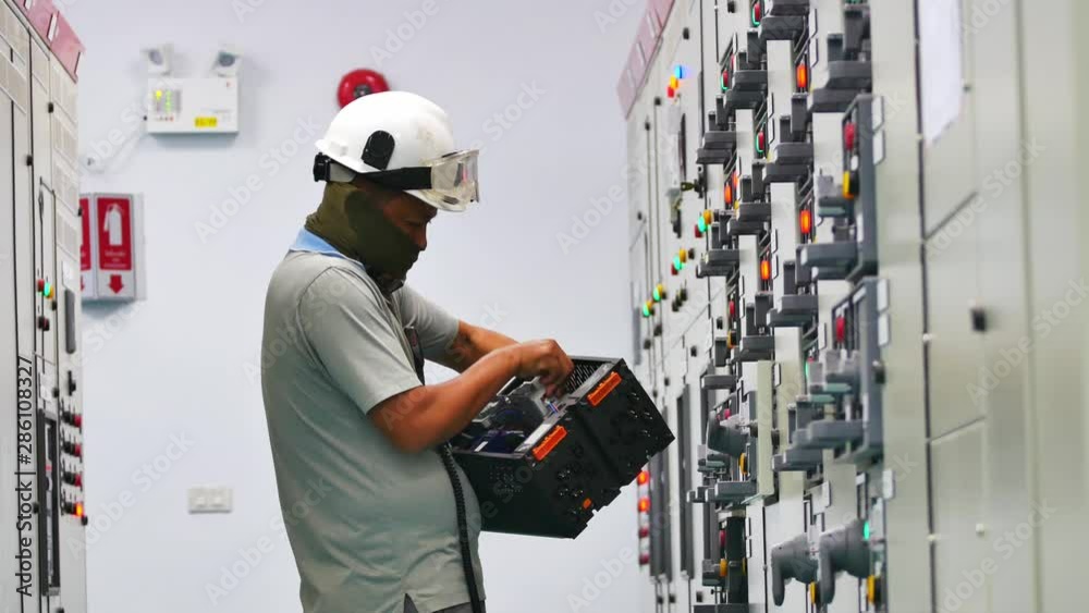 Maintenance Technician to check electrical device in Electricity substation building in industrial plant. Industrial and technology concept