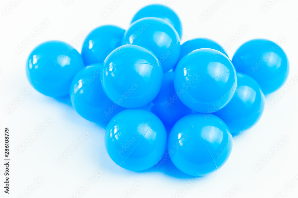 Isolate blue plastic balls in pool of game room. Dry Swimming pool for fun and jumping in plastic balls. The concept of celebration and fun Isolate blue plastic balls in pool of game room. Dry Swimming pool for fun and jumping in plastic balls. The concept of celebration and fun