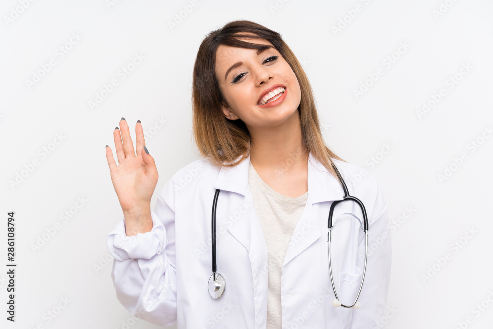 Young doctor woman over isolated background saluting with hand with happy expression Young doctor woman over isolated background saluting with hand with happy expression