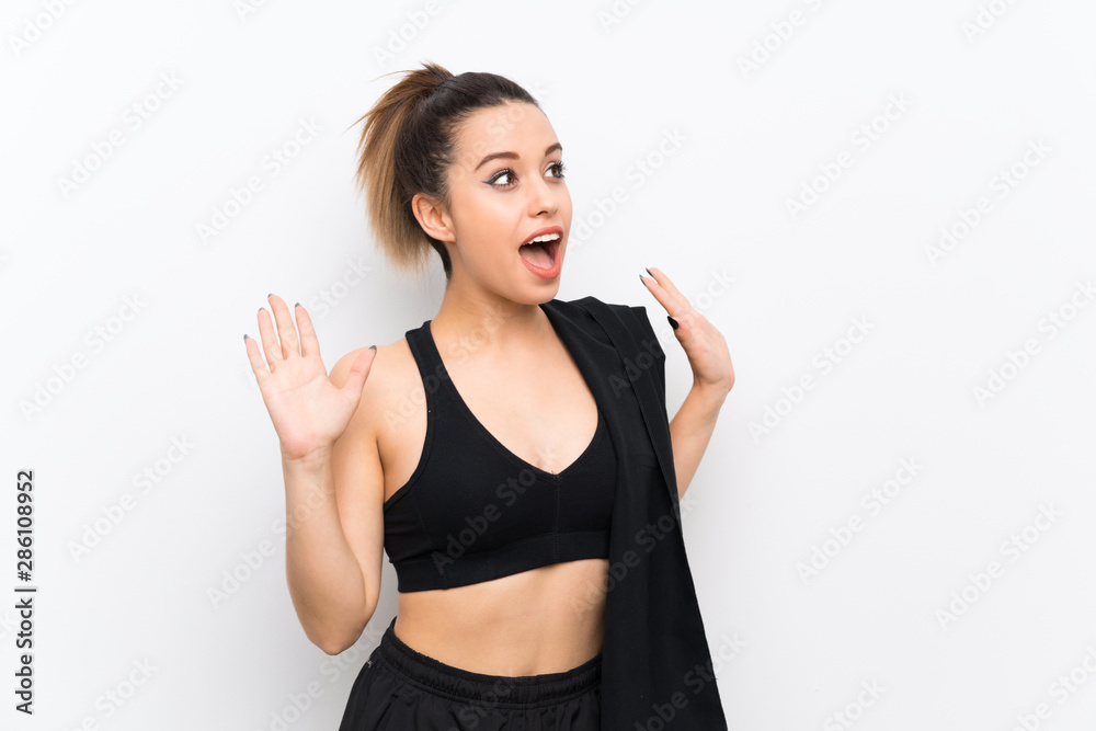Young sport woman over white wall with surprise facial expression Young sport woman over white wall with surprise facial expression