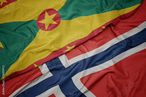 waving colorful flag of norway and national flag of grenada.