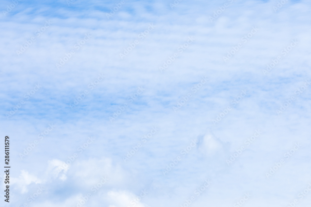 Obraz premium The vivid sky or heaven background with white and blue Cirrus and layered clouds under the sun rays