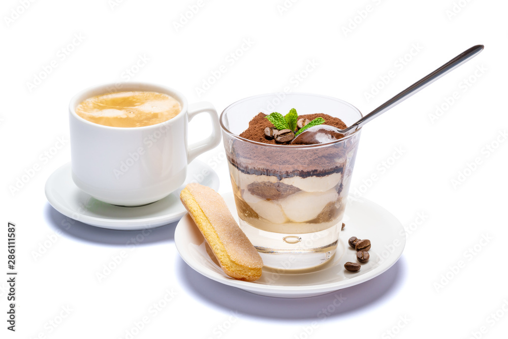 Classic tiramisu dessert in a glass cup, savoiardi cookies and coffee beans on white background with clipping path Classic tiramisu dessert in a glass cup, savoiardi cookies and coffee beans on white background with clipping path