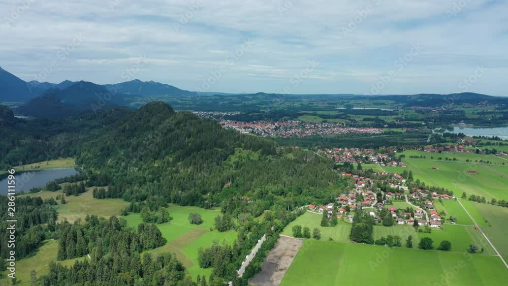 Aerial view of landscape around Neuschwanstein Castle, lush green hills of Bavarian Alps mountains in summer - panorama of Bavaria from above, Germany, Europe Aerial view of landscape around Neuschwanstein Castle, lush green hills of Bavarian Alps mountains in summer - panorama of Bavaria from above, Germany, Europe