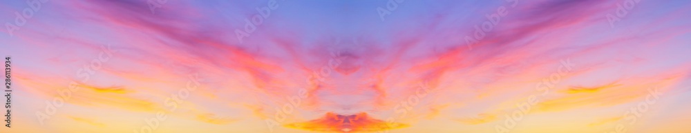 Fototapeta premium Collage with a horizontal reflection of the panorama of the sunset sky with pink layered clouds. Natural abstract adverse background