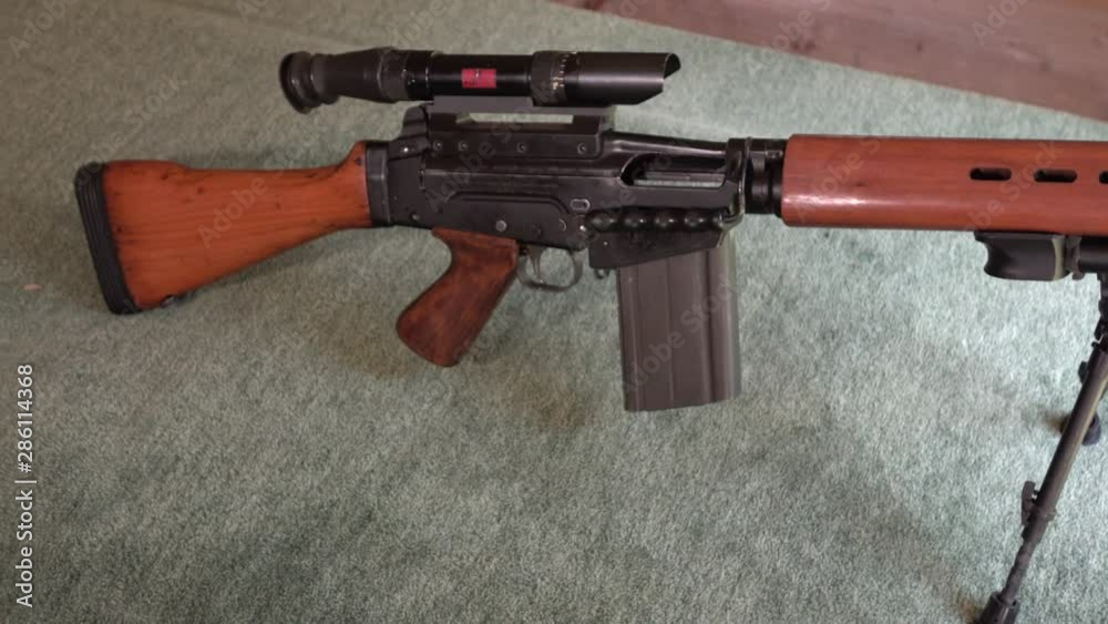 FAL rifle sitting idly on shooting range - wide