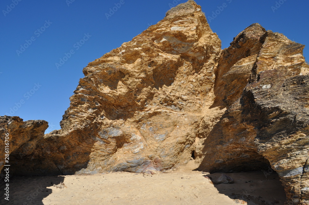 Iconic rock feature, a natural cave  at South Valla Beach with clear blue sky, Valla Beach, New South Wales, Australia