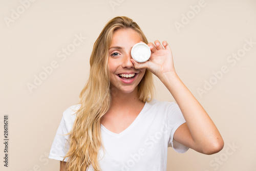Happy Young blonde woman with moisturizer