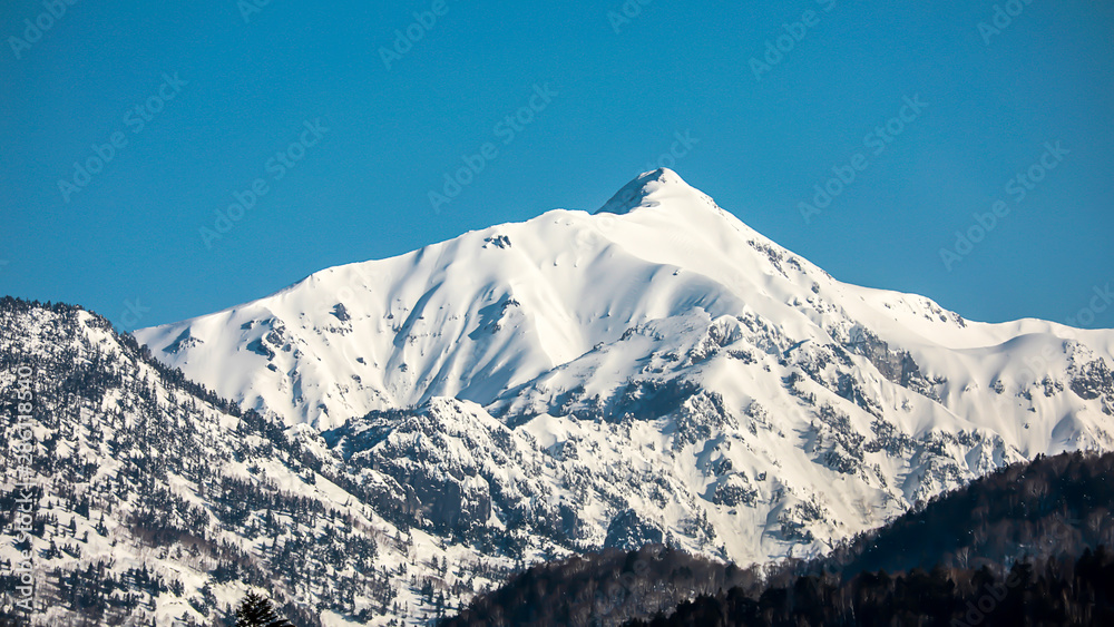 Landscape of the snow mountain with blue sky at Japan Alps Mountain. Winter season concept.