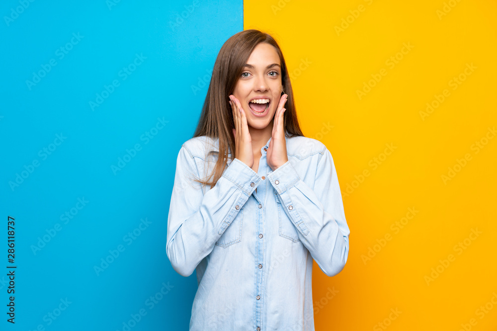 Young woman over colorful background with surprise facial expression Young woman over colorful background with surprise facial expression