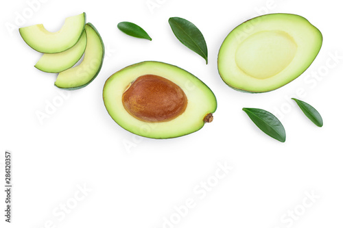 avocado and slices decorated with green leaves isolated on white background with copy space for your text. Top view. Flat lay