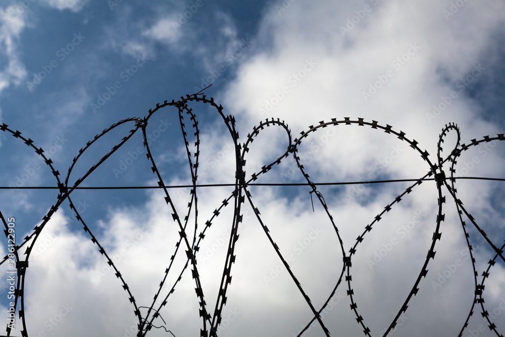 barbed wire on background of blue sky barbed wire on background of blue sky