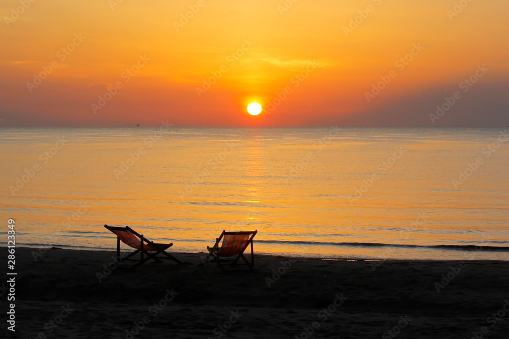 sunbed on the beach with sunrise background