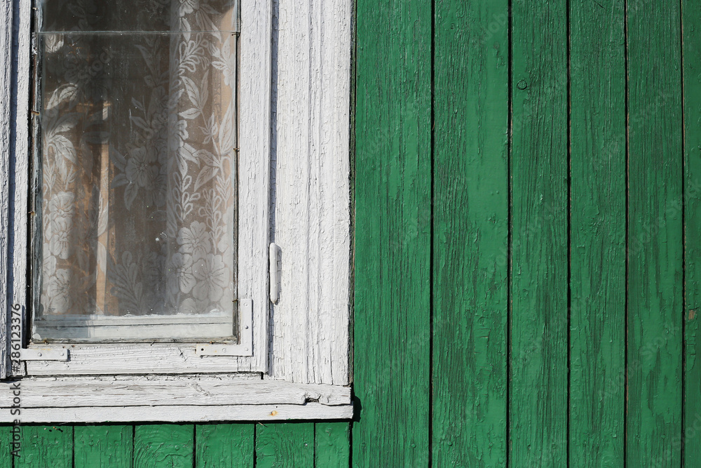 Part of white window and green wooden wall. Part of typical house in Lithuania, Trakai Part of white window and green wooden wall. Part of typical house in Lithuania, Trakai