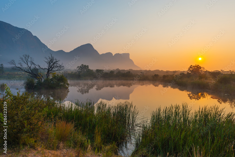 Magic sunrise landscape inside the Entabeni Safari Game Reserve with the Hanglip or Hanging Lip mountain peak, Waterberg, Limpopo Province, South Africa. - obrazy, fototapety, plakaty 