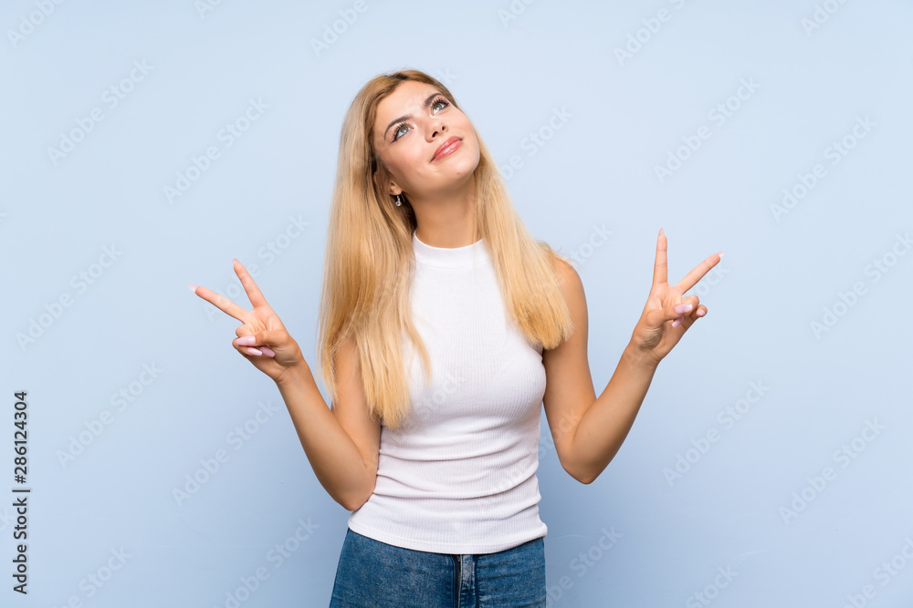 Teenager girl over isolated blue background laughing Teenager girl over isolated blue background laughing